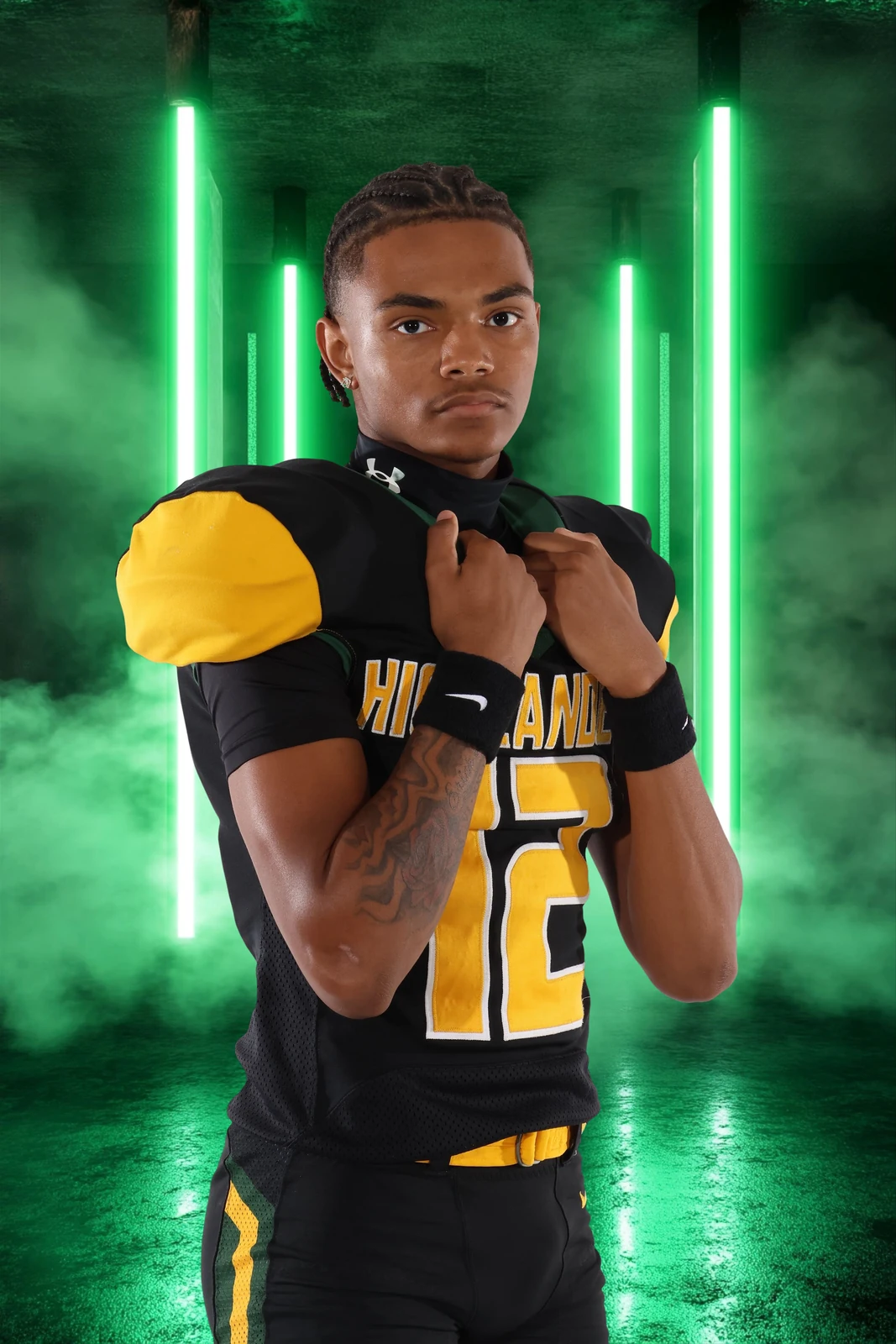 Football athlete portrait with dramatic green studio lighting