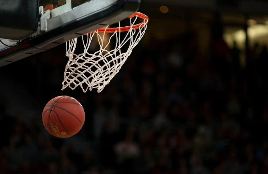 A basketball hoop and ball at a game